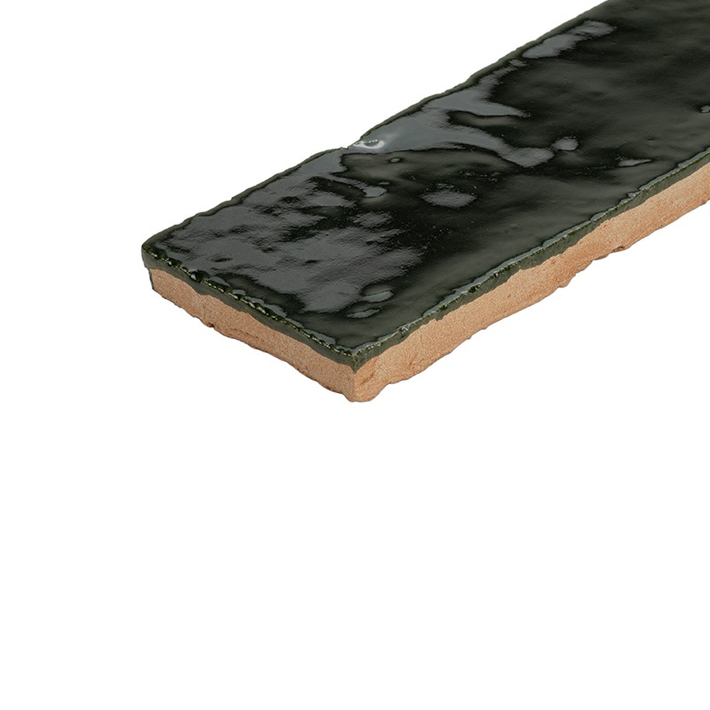 Long rectangular tile with brown ceramic base and irregular dark green glossy glaze; isolated on white background, highlighting side edge and glazed texture.
