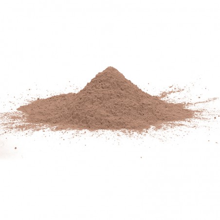 Um monte de pó fino e marrom repousa sobre uma superfície branca e lisa, espalhando-se levemente em torno de sua base.
