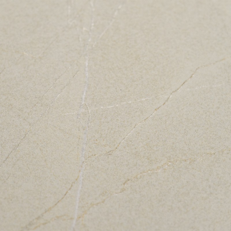 Smooth beige tile with fine veins and small cracks; flat surface occupies the frame, without other elements or visible context.