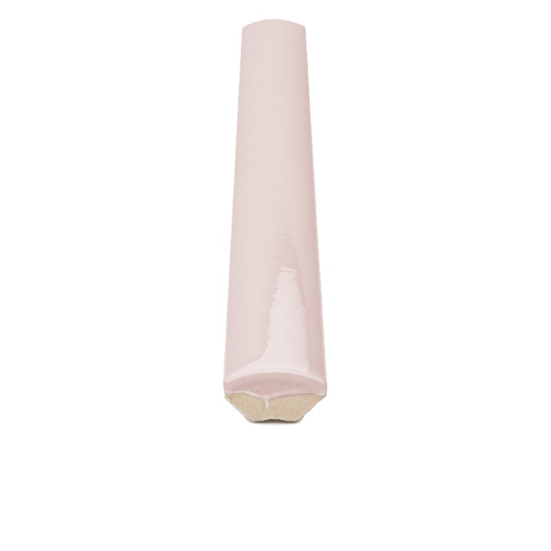 Pale pink curved ceramic tile with a bullnose finish and glossy glaze; beige inner edge visible on a uniform white background.