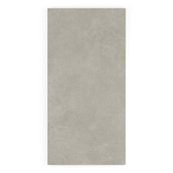 Un carreau rectangulaire gris repose à plat, affichant une texture lisse avec des marbrures subtiles, sur un fond blanc uni.