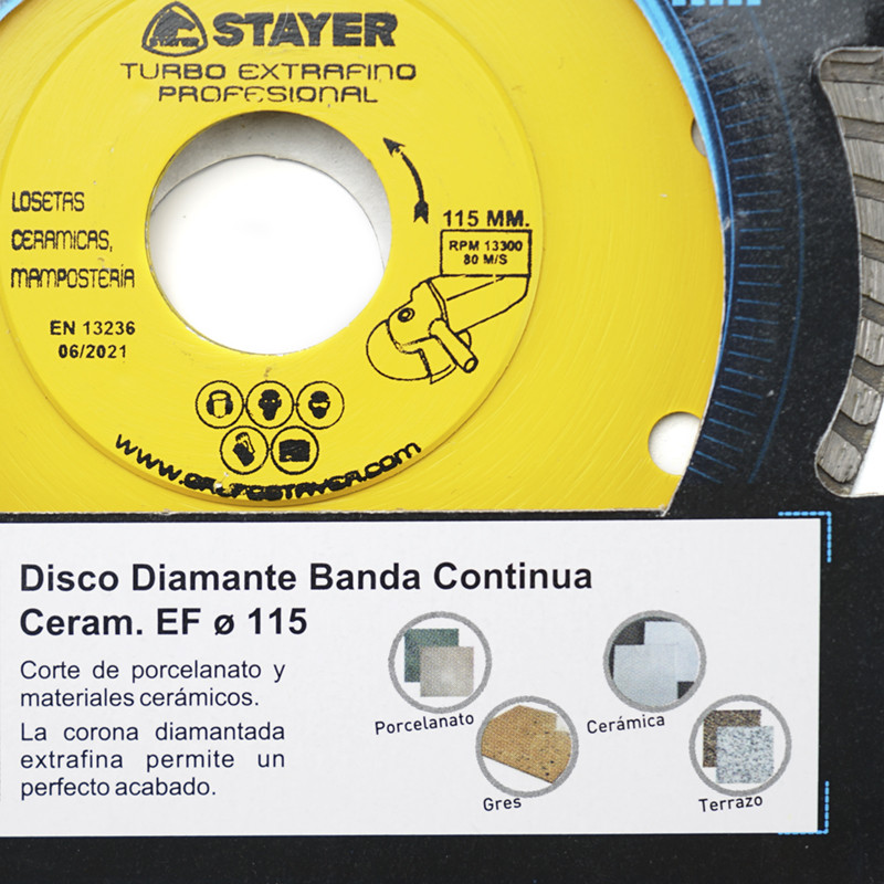 A yellow circular saw blade labeled `STAYER Turbo Extrafino Profesional` designed for cutting ceramic and masonry. Text includes