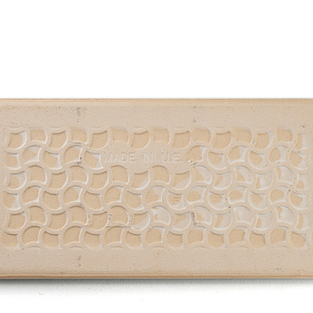 Eine rechteckige beige Fliese zeigt ein sich wiederholendes Muster aus ineinandergreifenden Halbkreisen. In der Mitte steht in s