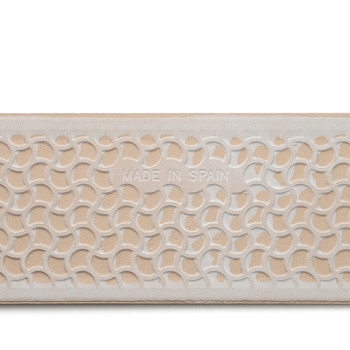 A rectangular tile features an abstract, interlocking arc pattern. Text reads `MADE IN SPAIN` in the center, with a beige and wh