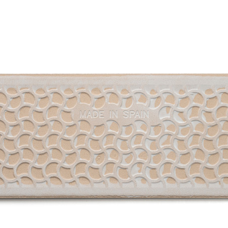 A rectangular tile features an abstract, interlocking arc pattern. Text reads `MADE IN SPAIN` in the center, with a beige and wh