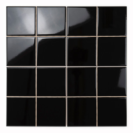 Sixteen glossy black tiles form a grid, reflecting light and showing slight distortions. The tiles are evenly spaced against a w Sixteen glossy black tiles form a grid, reflecting light and showing slight distortions. The tiles are evenly spaced against a w