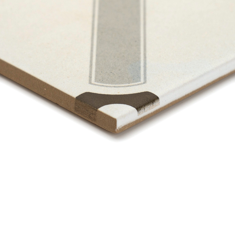 A ceramic tile features a geometric design with a central light gray rectangle and a contrasting dark brown corner, set against 
