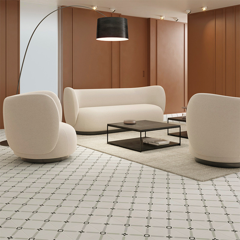 A modern living room featuring white armchairs and a sofa, arranged around a black coffee table on a beige rug, with a patterned