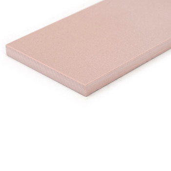 A rectangular, pink ceramic tile rests on a white background, featuring a smooth surface and slightly beveled edges.