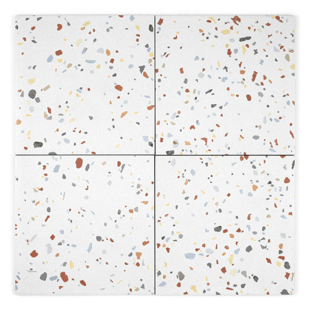 Four square tiles display a terrazzo pattern with scattered specks of orange, gray, blue, and yellow on a white background.