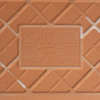 Een keramische tegel van terracotta heeft verhoogde ruitpatronen en de tekst in reliëf met de tekst `MAINZU Ceramica` en `MADE I