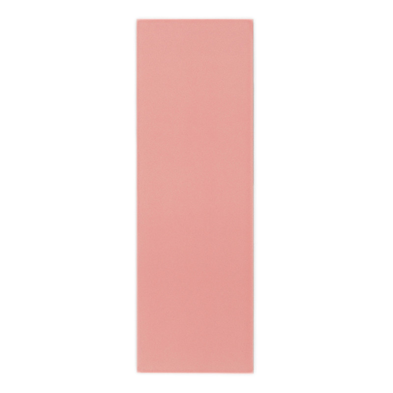 Un carreau rectangulaire rose uni repose debout sur un fond blanc uni, mettant en valeur sa surface lisse et mate.