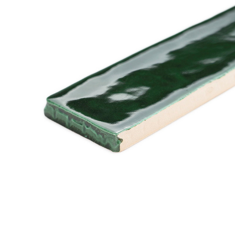 A rectangular, glossy green tile lies flat, reflecting light in a smooth surface pattern, set against a white background.