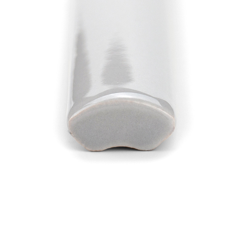 A smooth, glossy, white ceramic trim tile with a curved surface lies against a plain white background.