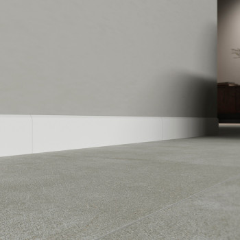 A floor of smooth gray baseboards extends towards a muted wall with white baseboard, creating a clean and modern interior space.