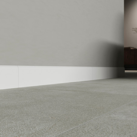 A floor of smooth gray baseboards extends towards a muted wall with white baseboard, creating a clean and modern interior space. A floor of smooth gray baseboards extends towards a muted wall with white baseboard, creating a clean and modern interior space.