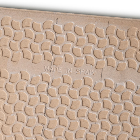 Tan tile features raised, crescent-shaped patterns with slightly uneven texture. Center text reads `MADE IN SPAIN,` indicating i