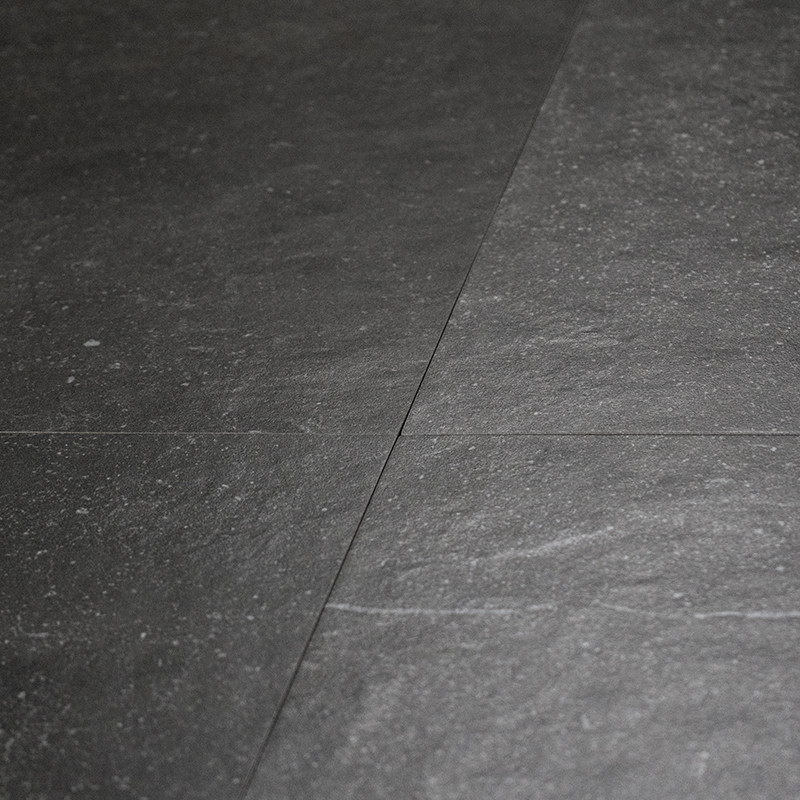 Dark slate tiles form a smooth, textured surface with subtle variations in tone, creating a natural, sophisticated flooring patt