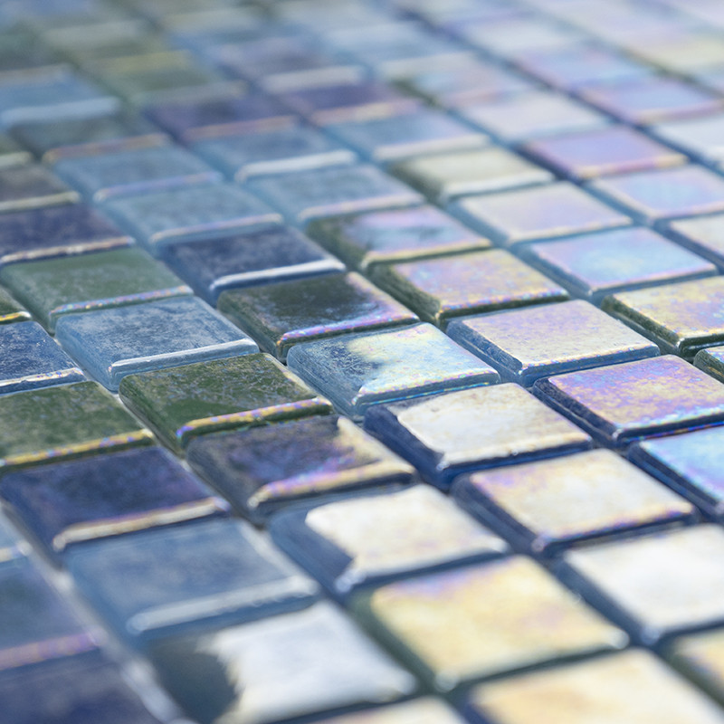 Ladrilhos de vidro cintilantes refletem a luz, criando um padrão colorido em uma superfície lisa e geométrica de mosaico.