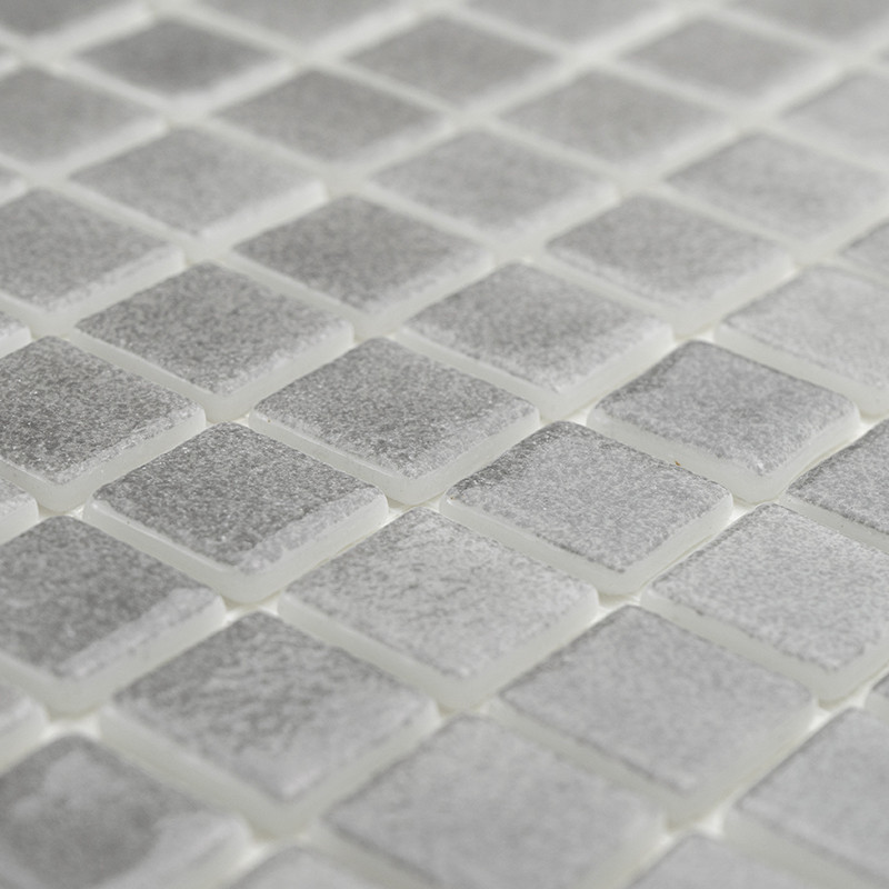 Square glass tiles shimmer subtly, forming a textured mosaic pattern. arranged neatly in an evenly spaced grid.
