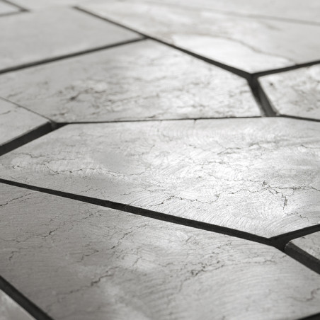 Los azulejos de piedra forman un patrón geométrico irregular con grietas visibles, situadas sobre una superficie lisa y de tonos Los azulejos de piedra forman un patrón geométrico irregular con grietas visibles, situadas sobre una superficie lisa y de tonos