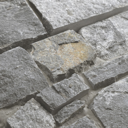 Rough gray stone tiles interlock, forming a textured surface. set in a light grout for an earthy, natural appearance. Rough gray stone tiles interlock, forming a textured surface. set in a light grout for an earthy, natural appearance.
