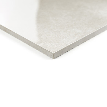 A square, light gray ceramic tile sits on a plain white background. the tiles smooth surface reflects light subtly.