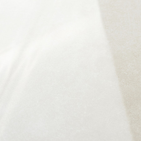 A smooth, glossy tile displays a subtle beige color gradient, transitioning from light to darker tones, under soft lighting.