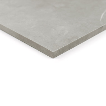 A smooth, gray ceramic tile rests on a white surface, showcasing its clean, angular edge, suggesting minimalistic and modern des