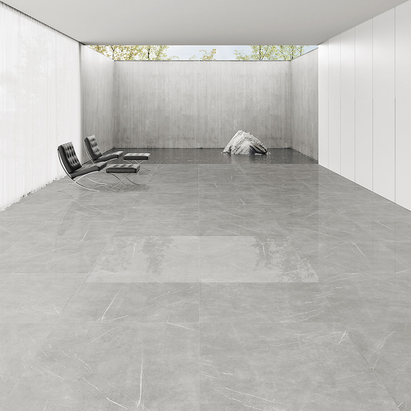 Suelo de azulejos de mármol gris que refleja la luz, situado en una habitación minimalista con paredes blancas y modernas sillas