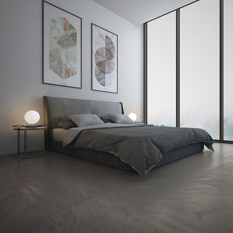 A modern bed is neatly made with dark bedding, flanked by round lamps on sleek tables in a minimalistic room with large windows 