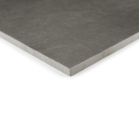 A dark, rectangular ceramic tile rests flat against a white background, showing a textured surface and smooth edges at the corne