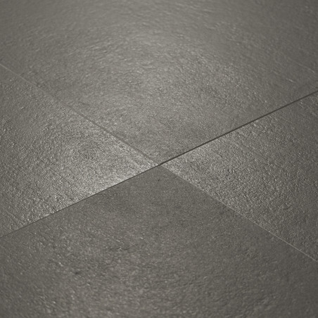 Dark gray textured tiles are arranged in an intersecting grid pattern, displaying a natural stone finish in a well-lit indoor se
