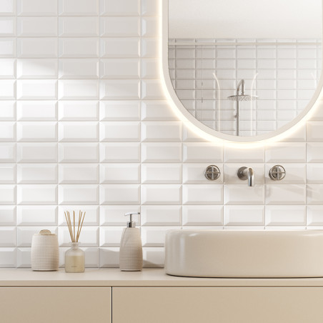 White rectangular tiles form a textured backsplash. a round mirror and faucet are mounted above a beige countertop with toiletri White rectangular tiles form a textured backsplash. a round mirror and faucet are mounted above a beige countertop with toiletri