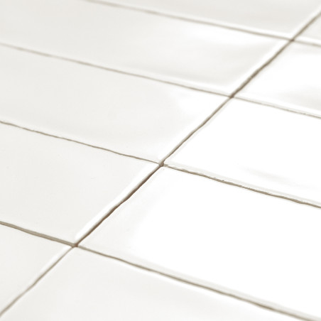Glossy white rectangular tiles are neatly arranged in a grid pattern, reflecting light. context suggests a clean, modern surface Glossy white rectangular tiles are neatly arranged in a grid pattern, reflecting light. context suggests a clean, modern surface