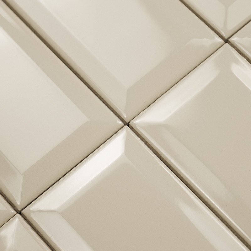 Les carreaux de céramique brillants forment un motif en grille. les formes rectangulaires sont surélevées, créant un effet bisea
