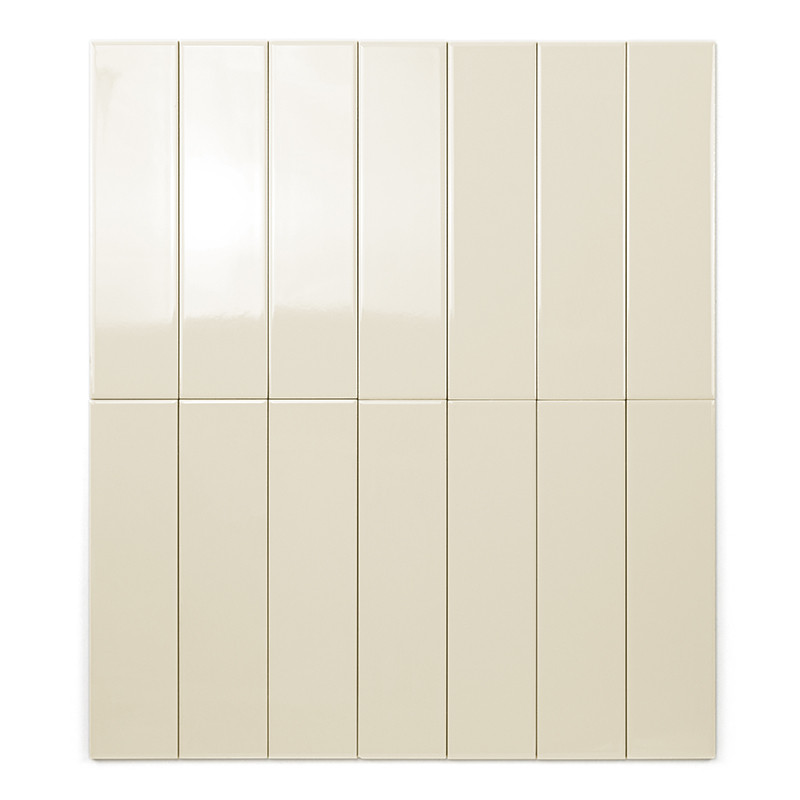 A long, rectangular beige tile rests vertically on a white background, showcasing its smooth and uniform surface without any tex