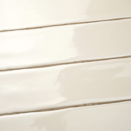 Glänzende, rechteckige Fliesen werden horizontal ausgerichtet, wodurch eine glatte, glatte Oberfläche entsteht. Die sanfte, crem