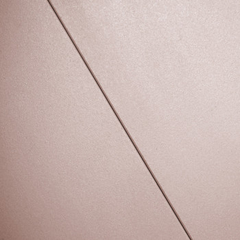 A smooth, beige tile is intersected by a fine diagonal line, creating a subtle division in a plain, minimalist surface.