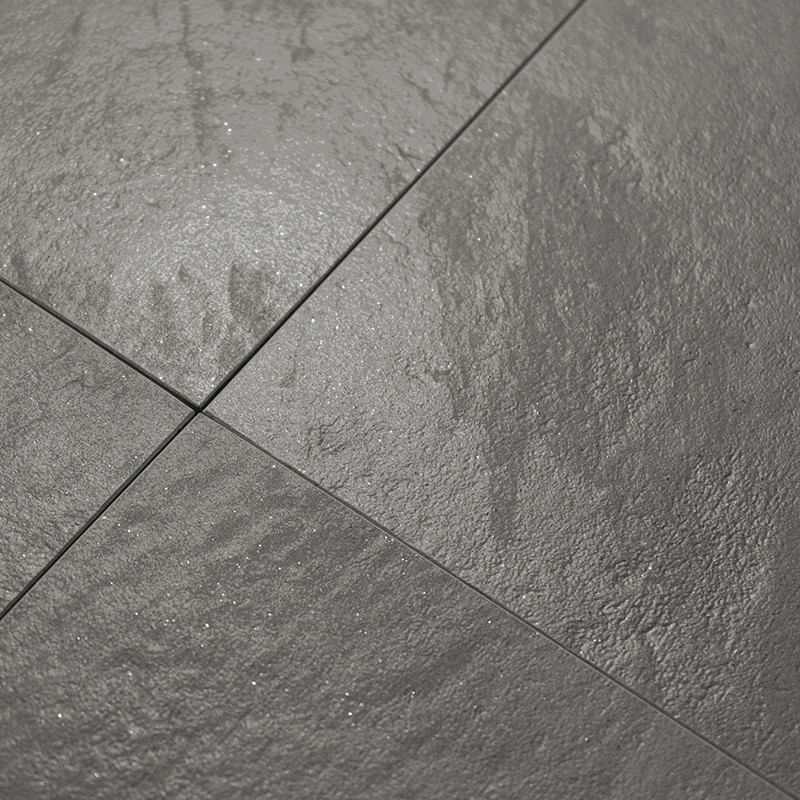Gray tiles form a textured, shiny surface, arranged in a grid pattern with intersecting lines, reflecting light subtly across th