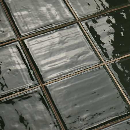 Shiny, dark green ceramic tiles reflect light, arranged in a neat grid with visible grout lines, creating a glossy, textured sur Shiny, dark green ceramic tiles reflect light, arranged in a neat grid with visible grout lines, creating a glossy, textured sur