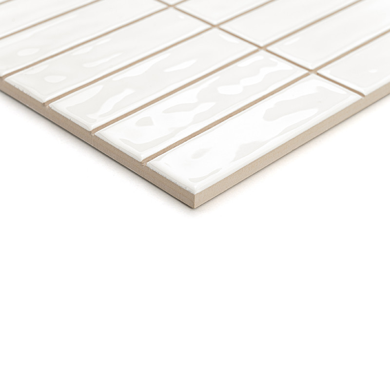 Glossy white rectangular tiles are laid in a staggered pattern, creating a modern geometric design against a neutral background.