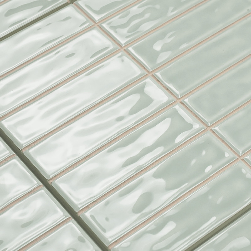 Carreaux rectangulaires brillants disposés en quinconce, réfléchissant la lumière, avec une douce couleur vert menthe et une tex