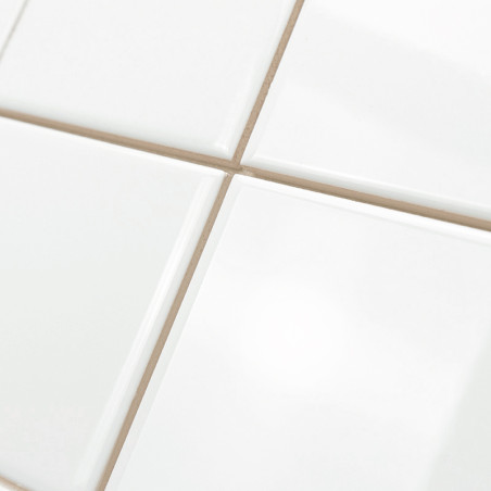 Square ceramic tiles are arranged symmetrically, forming a grid with thin, light-colored grout lines, creating a clean and minim