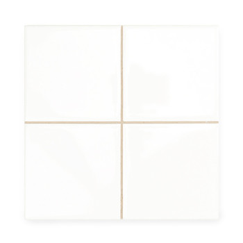 Four smooth, white ceramic tiles are aligned, forming a larger square. Thin beige grout lines separate them, creating a neat gri
