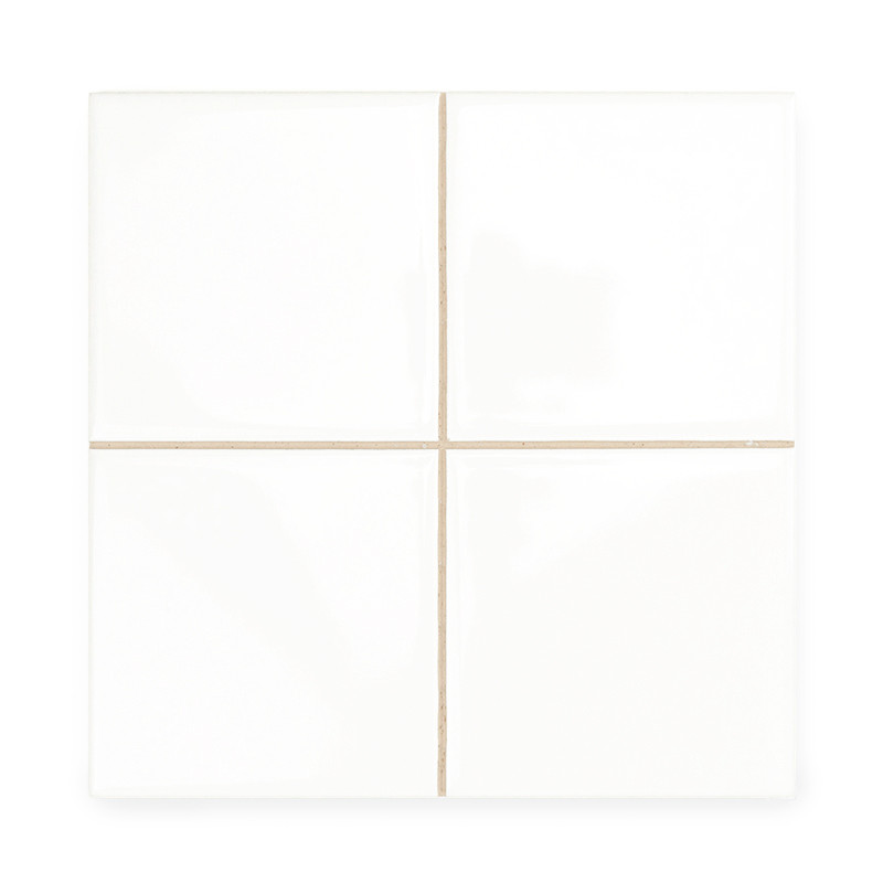 Four smooth, white ceramic tiles are aligned, forming a larger square. Thin beige grout lines separate them, creating a neat gri