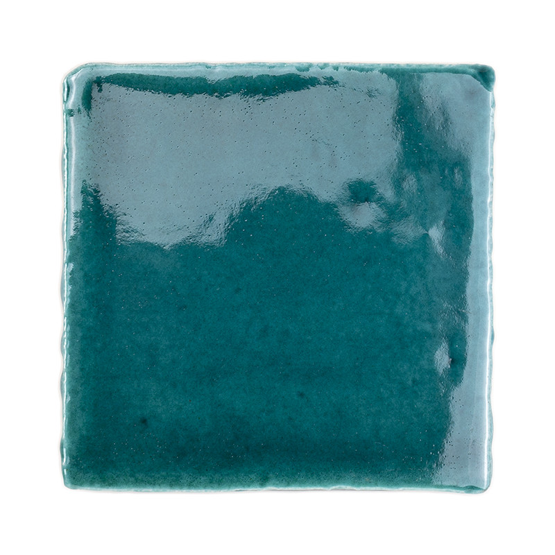 A glossy, square terracotta tile reflects light, showcasing a deep teal color in a plain, white background.