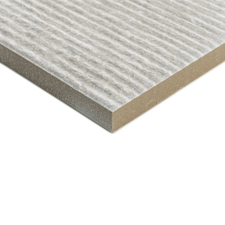 A rectangular, textured tile has a striped surface pattern, resting flat against a plain white background, emphasizing its layer A rectangular, textured tile has a striped surface pattern, resting flat against a plain white background, emphasizing its layer
