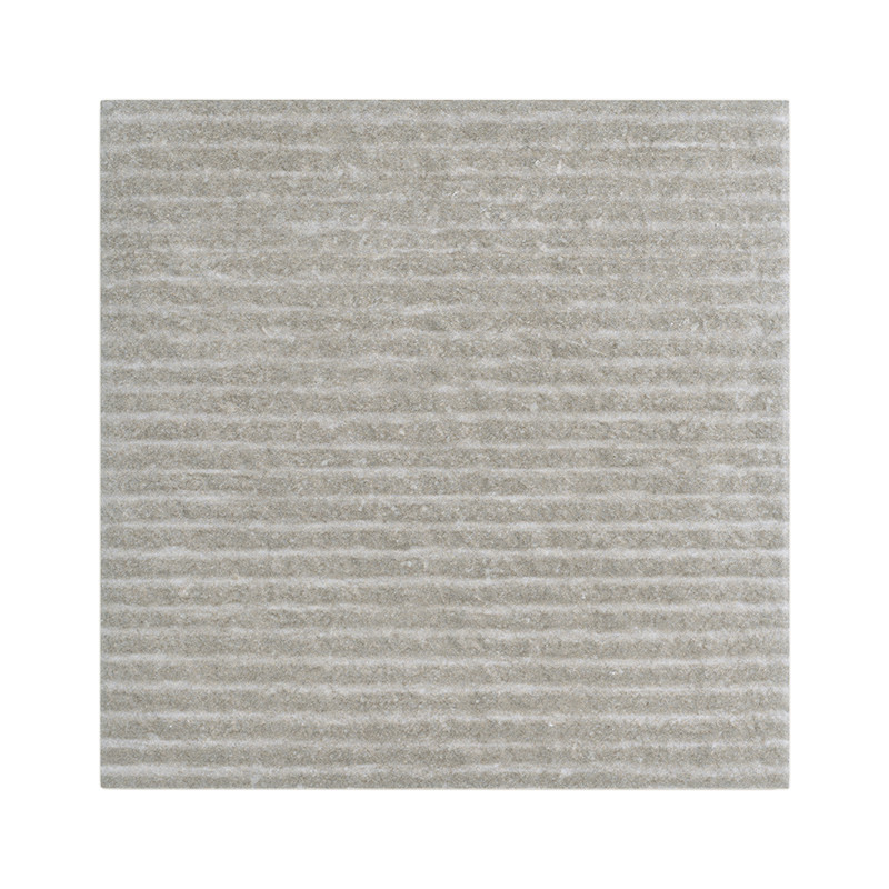A square, light gray tile displays a textured surface and horizontal grooves, set against a plain, neutral backdrop.