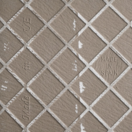 Fliesenbild: Diagonal angeordnete quadratische Fliesen mit strukturierter, matter Oberfläche. Der Text lautet „MADE IN SPAIN“, t
